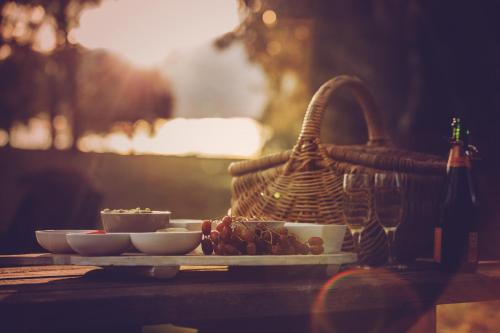 a plate of food on a table with a basket at Evanslea Luxury Boutique Accommodation in Mudgee