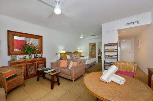 a living room with a couch and a table at Seascape Holidays at Portsea in Port Douglas