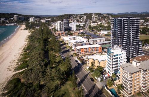 an aerial view of a beach and buildings at Boardwalk Burleigh Beach - Official in Gold Coast