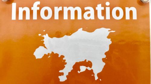 a sign with the words information on a orange wall at Shodoshima Olive Youth Hostel in Shodoshima