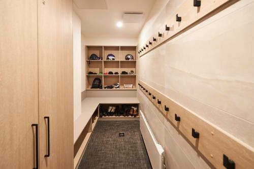 a walk in closet with shoes on shelves at Mt Buller Chalet Hotel & Suites in Mount Buller