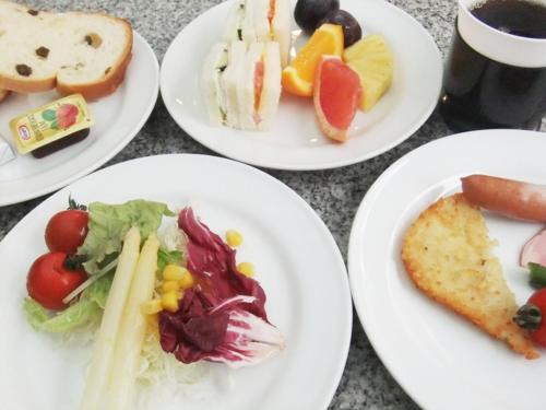 a group of plates of food on a table at Arrow Hotel in ShinsaiBashi 朝食無料サービス中 in Osaka