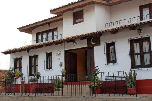 a white house with a red and white at Meson Luna Sacra in Tapalpa