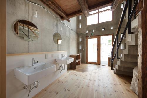 a bathroom with two sinks and a large window at Sai no Tsuno Guest House in Ueda