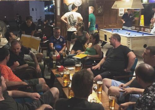 a group of people sitting in a room at Noom Guesthouse in Lop Buri