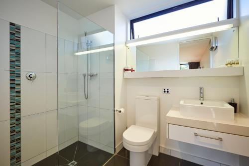 a bathroom with a toilet and a sink and a shower at The Fairways Accommodation Kaikoura in Kaikoura