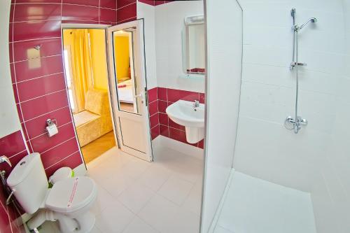 a bathroom with a toilet and a sink at Villas Sequoia in Golden Sands