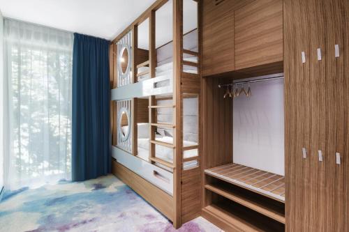 a dressing room with wooden cabinets and shelves at Hotel Testa in Sopot