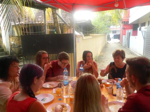 a group of people sitting at a table eating at Prems Homestay in Cochin