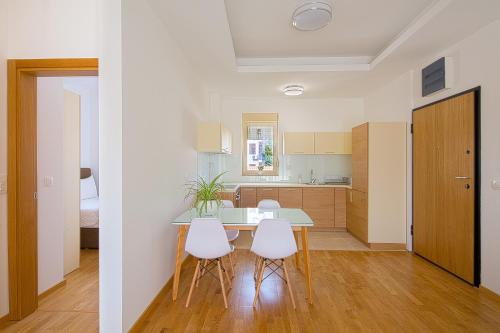 a kitchen and dining room with a table and chairs at Eukaliptus in Becici