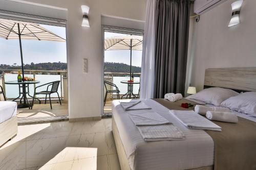 a bedroom with a bed and a balcony with a view at Zara apartmani Sutomore in Sutomore