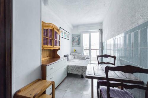 a small room with a bedroom with a bed and a table at Nice Promenade des Anglais in Nice