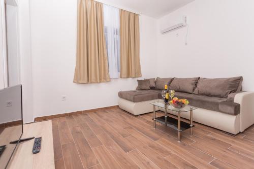 a living room with a couch and a table at Resort Bevilacqua in Budva