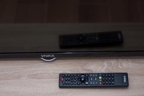 two remote controls sitting on top of a table at Resort Bevilacqua in Budva