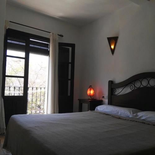 a bedroom with a large bed and a window at Casa Lareymora in Algarrobo
