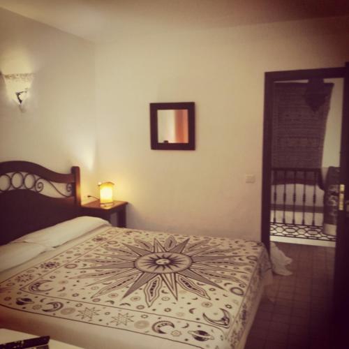 a bedroom with a bed with a design on it at Casa Lareymora in Algarrobo