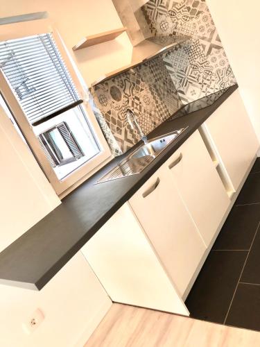 a kitchen with a sink and a counter top at Seaview Apartment in Koper