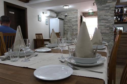 a dining room table set for a dinner at B&B Millenium House in Plitvička Jezera