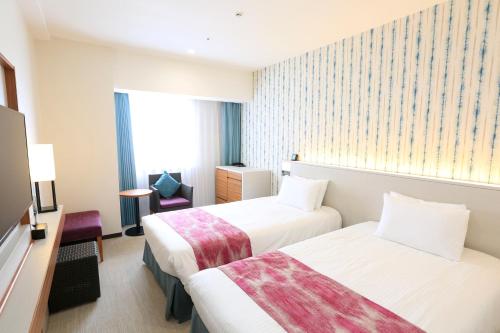 Katil atau katil-katil dalam bilik di Hotel JAL City Naha