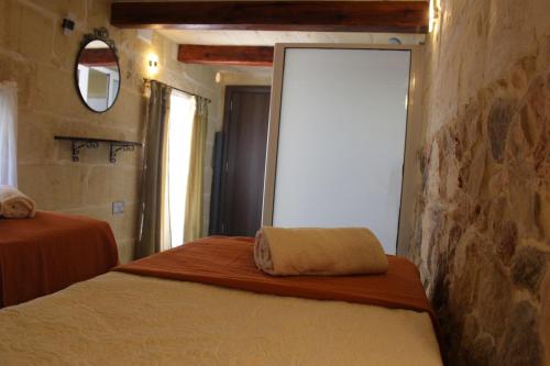 a bedroom with two beds and a mirror and a window at Simar in Qala