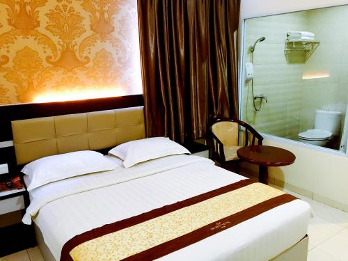 a hotel room with a bed and a bath tub at De Best Hotel in Nagoya