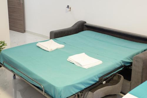 a hospital bed with two pillows on it at For Rest Aparthotel in St Paul's Bay