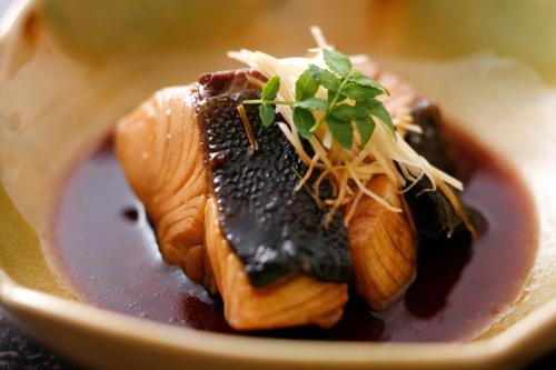 a plate of food with meat and sauce on it at Tabinoyado Ushionoakari Geiboso in Shima