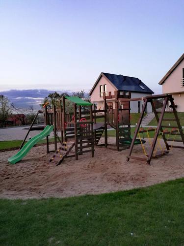 a group of playground equipment in a park at Całoroczne domy do wynajęcia in Narty