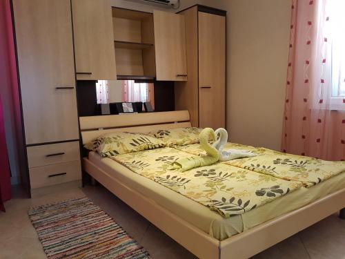 a bedroom with a bed and a dresser at Apartments Mara in Novi Vinodolski