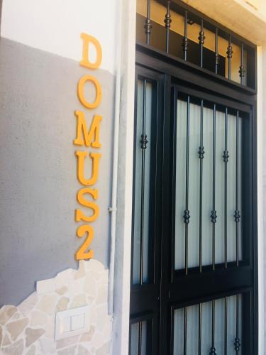 a sign on the side of a building with a door at Domus Stadio in Naples