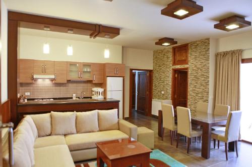 a living room and kitchen with a couch and a table at Cedars Palace in Al Arz