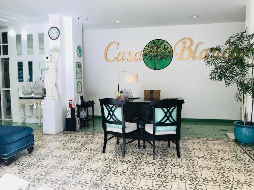 a dining room with a black table and chairs at Casa Blanca Boutique Hotel - SHA Plus in Phuket Town