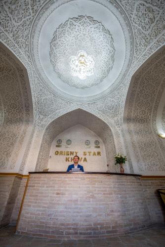 a ceiling in a building with a chandelier at Orient Star Khiva Hotel- Madrasah Muhammad Aminkhan 1855 in Khiva