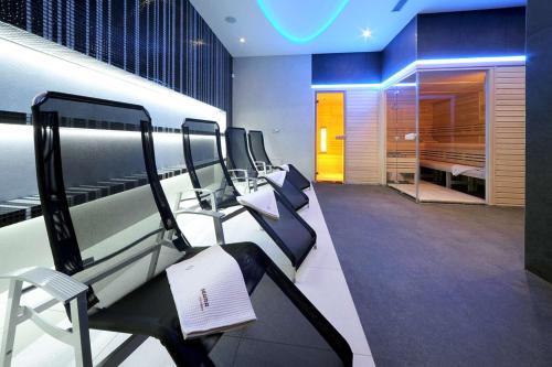 a room with a row of chairs and a salon at Sport & Relax Hotel Davidek in Trutnov