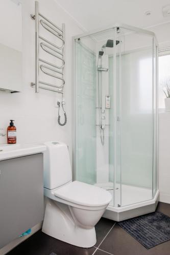 a bathroom with a toilet and a glass shower at Gränna Lakeview in Gränna