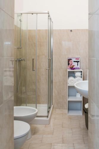 a bathroom with a shower and a toilet and sink at La Casa del Barocco in Noto
