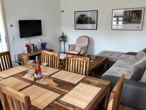 a living room with a table and a couch at Riesling House Laa in Laa an der Thaya
