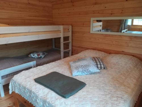 a bedroom with two bunk beds and a mirror at Tohninmäen Talo in Töysä