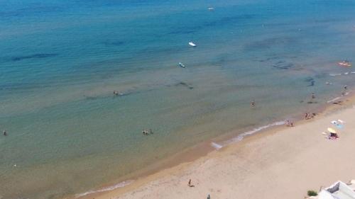 an aerial view of a beach with people in the water at Villa Sunshine in Triscina