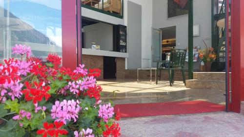 a bunch of flowers in front of a building at Motel des Sports Martigny in Martigny-Ville