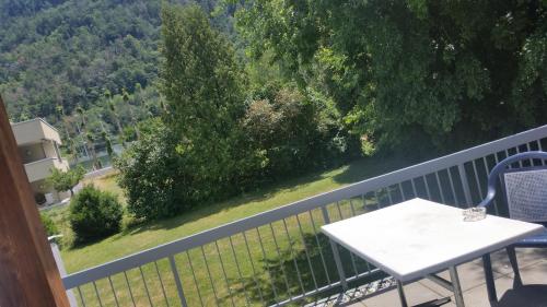 a table and chairs on a balcony with a view at Motel des Sports Martigny in Martigny-Ville