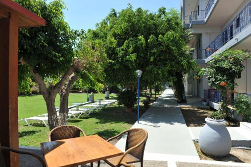 a table and chairs on a sidewalk next to a building at Maritime in Kremasti