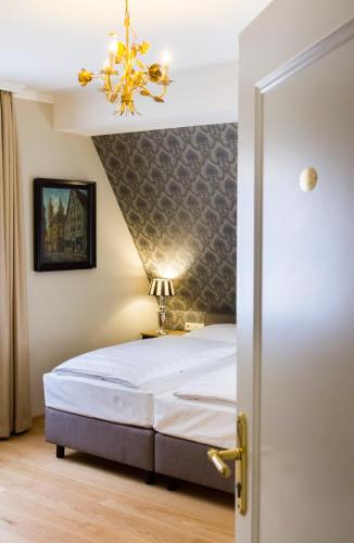Ένα ή περισσότερα κρεβάτια σε δωμάτιο στο Hotel Reichsküchenmeister