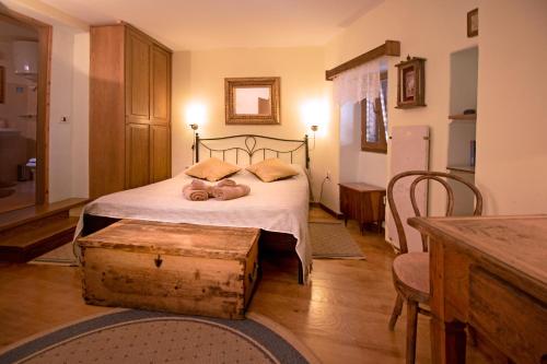 a bedroom with a bed with two teddy bears on it at Kamene Priče rooms, music and food in Bale
