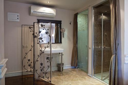 a bathroom with a shower and a sink at Kitapevi Hotel in Bursa