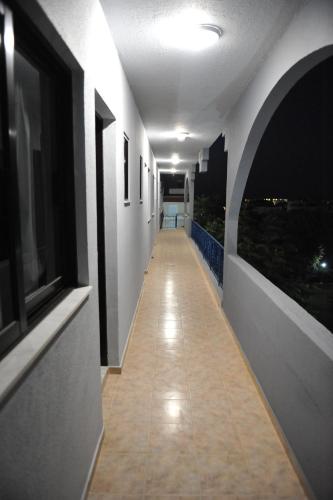 a hallway of a building with a view of the city at Maritime in Kremasti