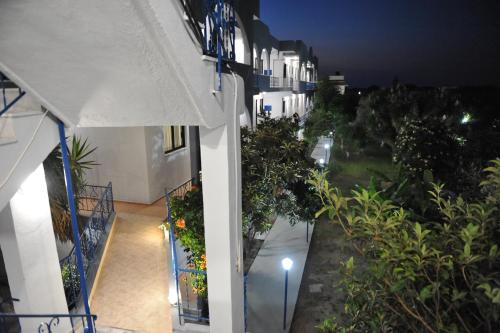 a view of a balcony of a building at night at Maritime in Kremasti