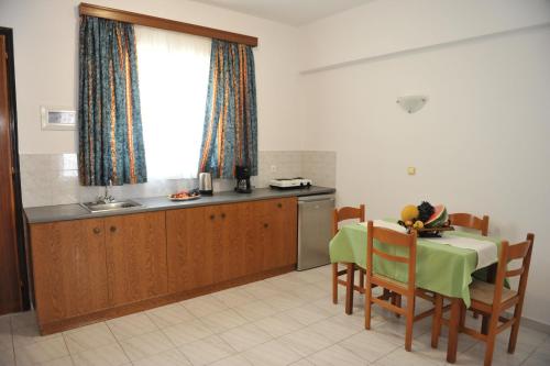 a kitchen with a table and a table and chairs at Maritime in Kremasti