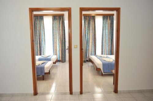 a room with two beds and two mirrors at Maritime in Kremasti