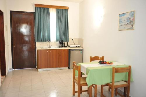 a kitchen and dining room with a table and chairs at Maritime in Kremasti
